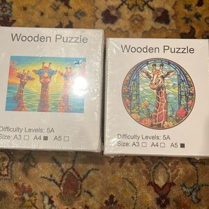 Two wooden puzzles both with a giraffe theme new sealed box never opened
